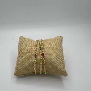 Elegant Gold Bracelet with Red and Green Accents